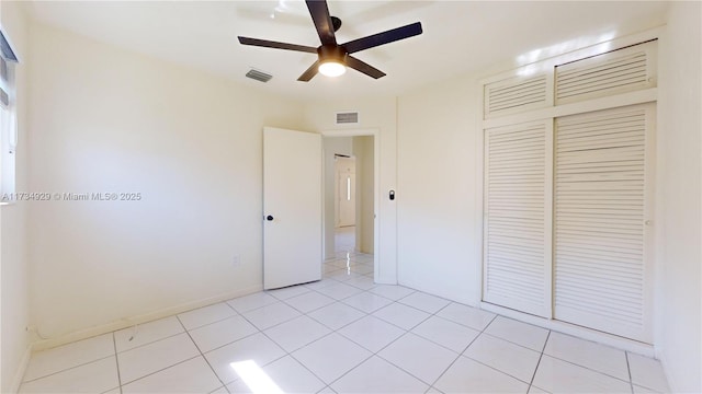 unfurnished bedroom featuring light tile patterned floors, ceiling fan, and a closet