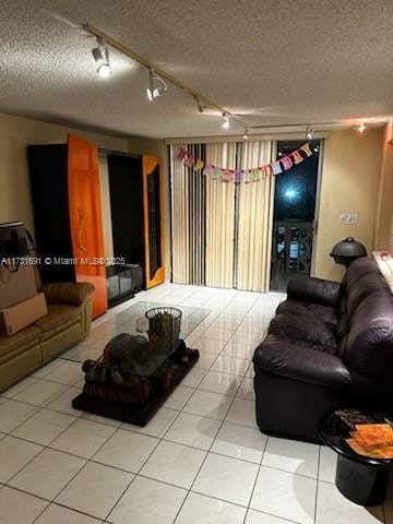 living room featuring tile patterned flooring and a textured ceiling