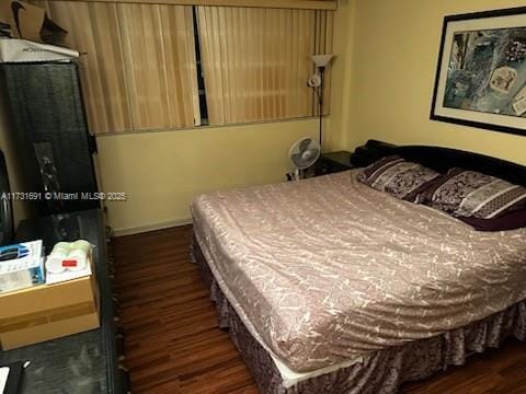 bedroom featuring dark hardwood / wood-style flooring