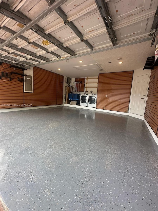 garage with washing machine and dryer and electric panel