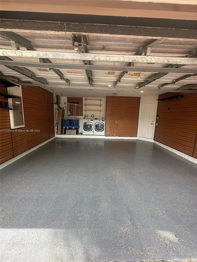 garage featuring washing machine and dryer and electric panel