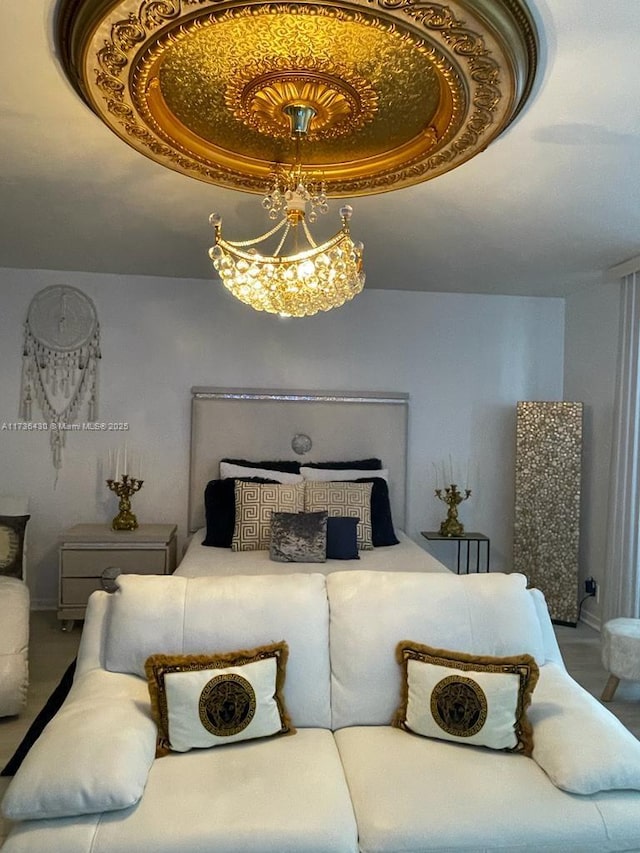 bedroom with a notable chandelier and a tray ceiling