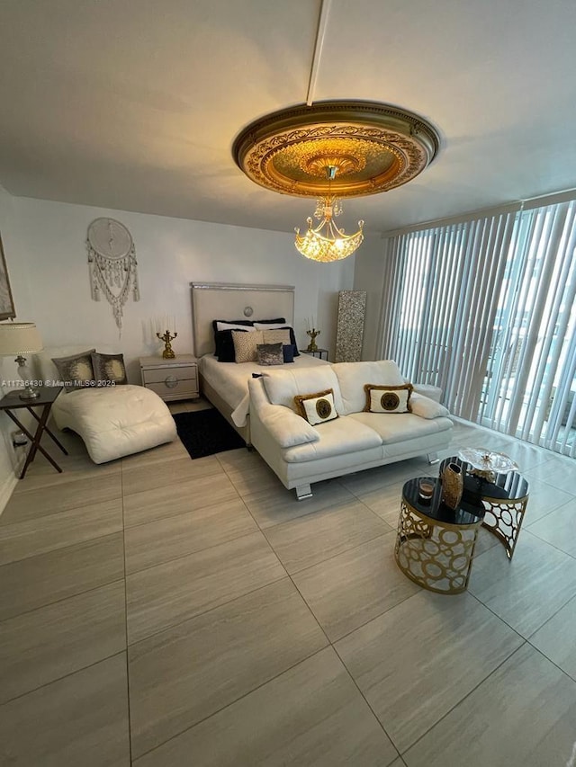 bedroom with expansive windows and a chandelier