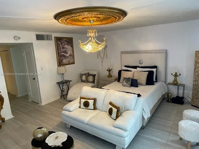 bedroom featuring a tray ceiling and light wood-type flooring