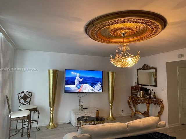 living room with a raised ceiling and a chandelier