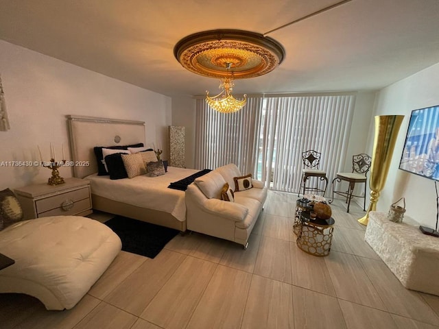 bedroom with an inviting chandelier and a wall of windows