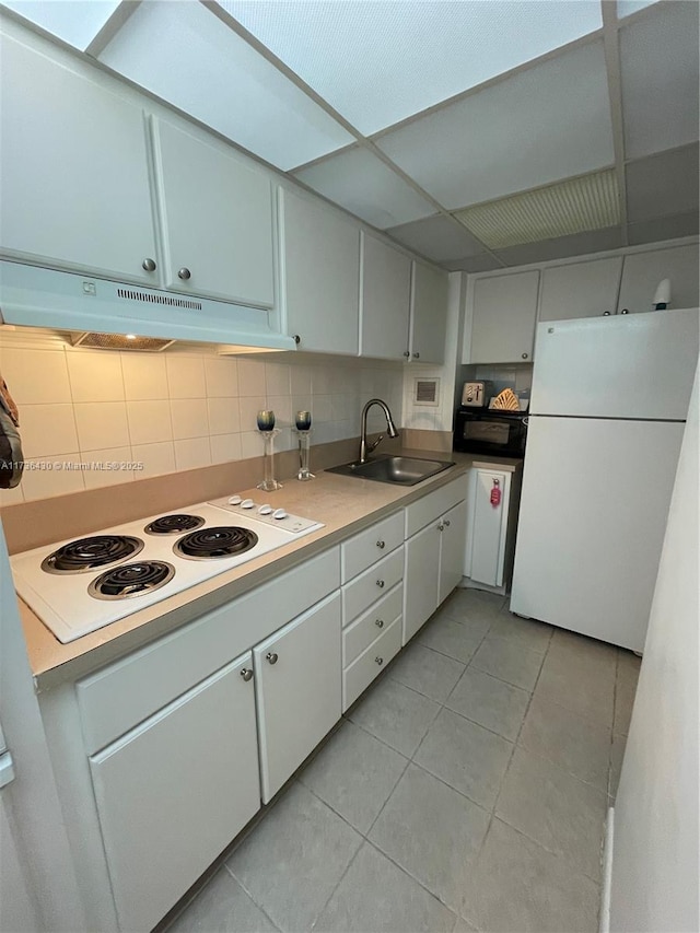 kitchen featuring white cabinets, white appliances, sink, and backsplash