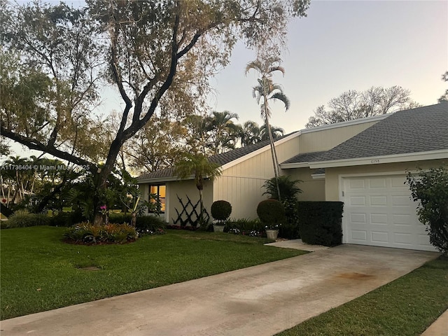 view of home's exterior with a yard and a garage