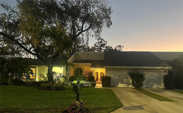 view of front of house featuring a yard and a garage