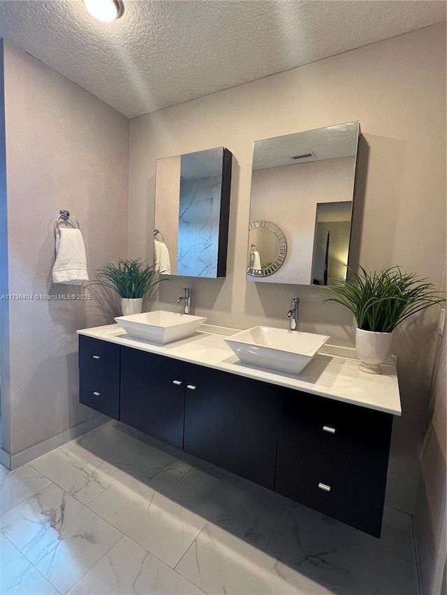 bathroom with vanity and a textured ceiling