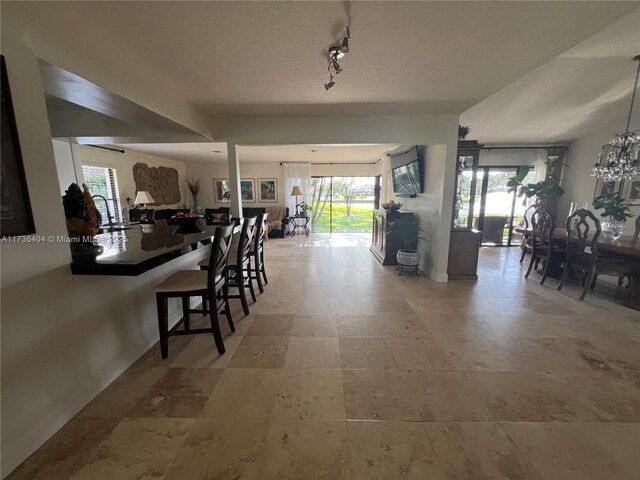 sunroom featuring a water view