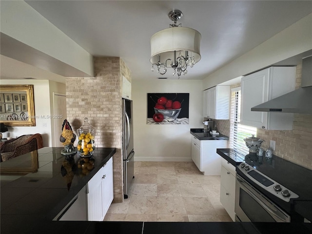 kitchen featuring pendant lighting, backsplash, stainless steel appliances, and white cabinets