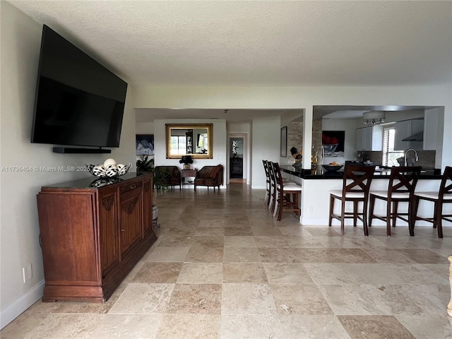 living room with a healthy amount of sunlight and a textured ceiling