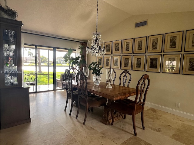 dining space featuring vaulted ceiling and a notable chandelier