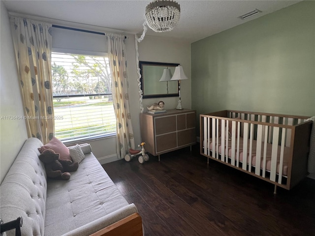 bedroom with dark wood-type flooring