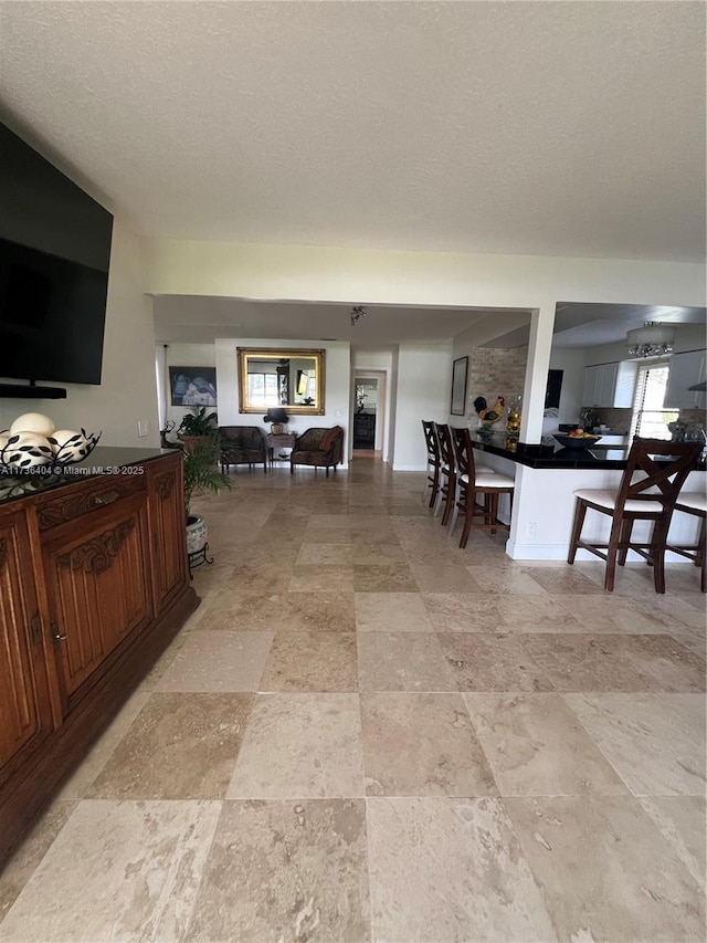 interior space with a healthy amount of sunlight and a textured ceiling