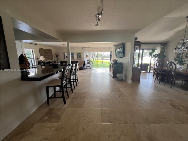 dining room featuring rail lighting and sink