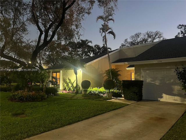 exterior space with a garage and a yard