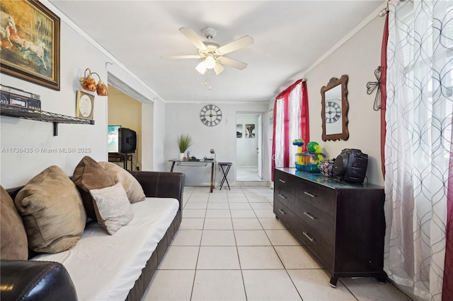 living room with crown molding, light tile patterned flooring, and ceiling fan