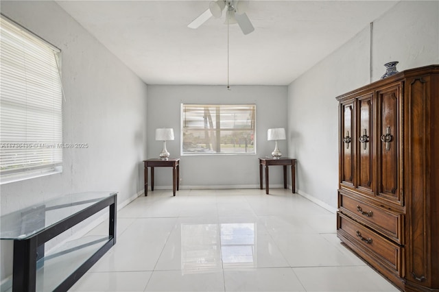 interior space with ceiling fan and light tile patterned floors