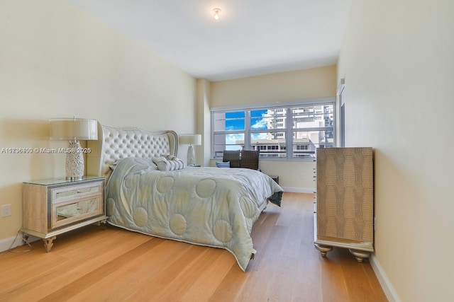 bedroom with wood-type flooring