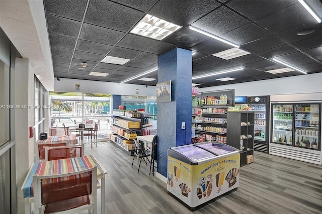 interior space featuring hardwood / wood-style flooring and a drop ceiling