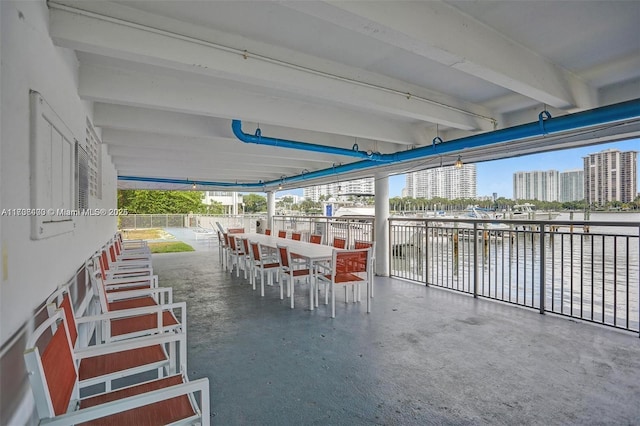 view of patio / terrace featuring a water view and exterior bar