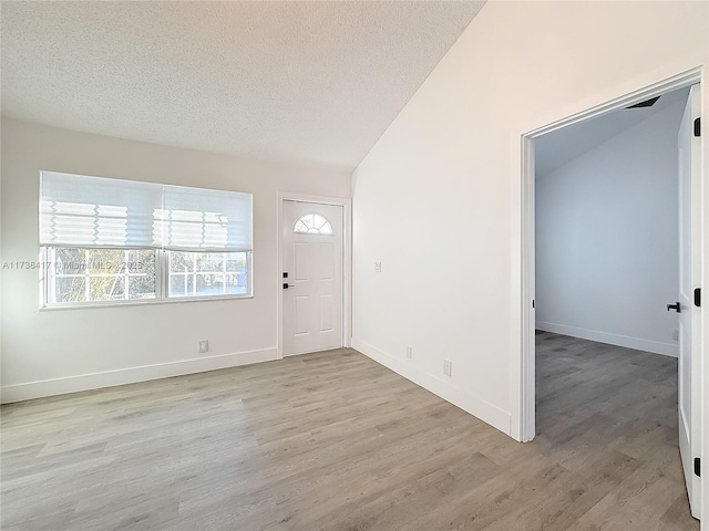 entryway featuring a textured ceiling and light wood-type flooring