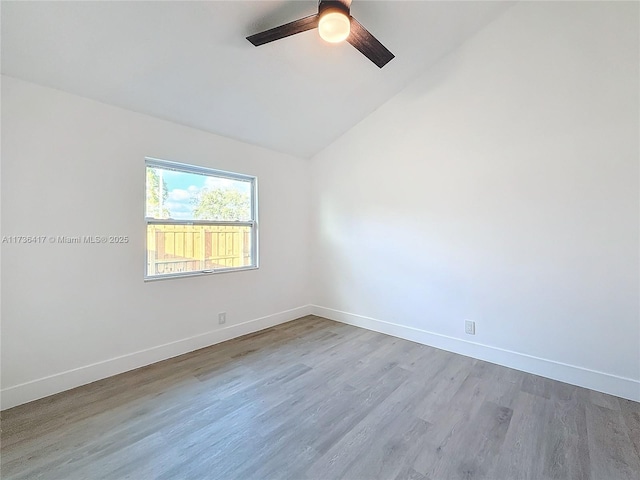 spare room featuring ceiling fan, lofted ceiling, and light hardwood / wood-style floors