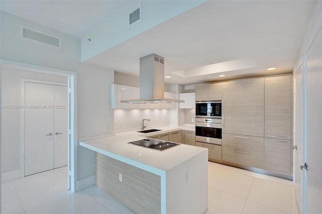 kitchen with sink, light tile patterned floors, kitchen peninsula, island exhaust hood, and black appliances