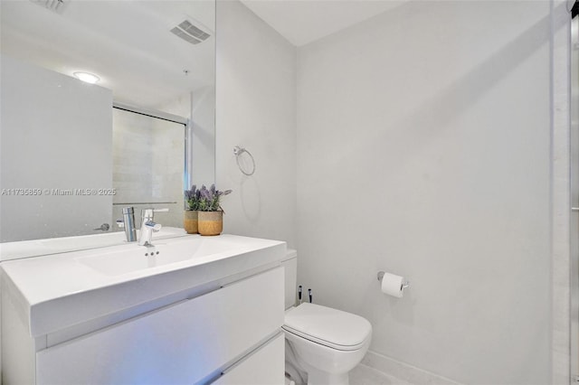 bathroom with vanity, toilet, and walk in shower