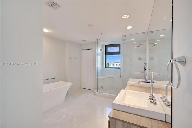 bathroom with tile patterned floors, vanity, and independent shower and bath