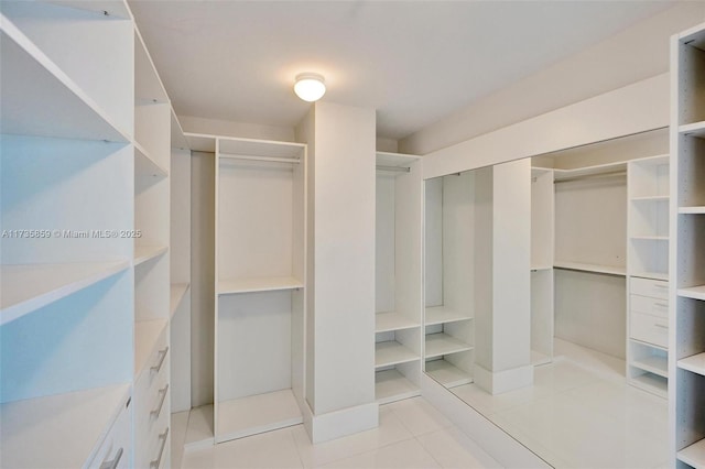 spacious closet with light tile patterned flooring