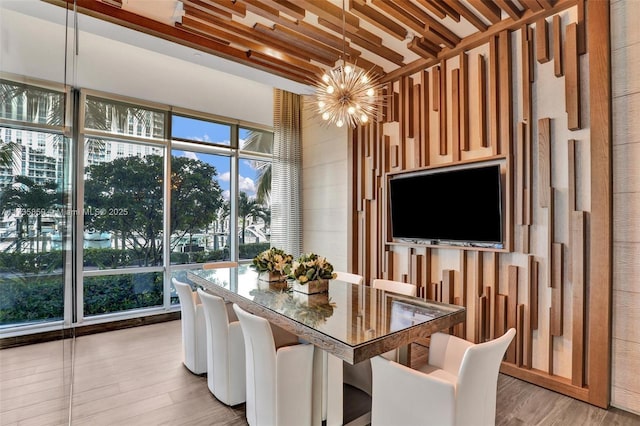 dining space featuring an inviting chandelier and light hardwood / wood-style floors