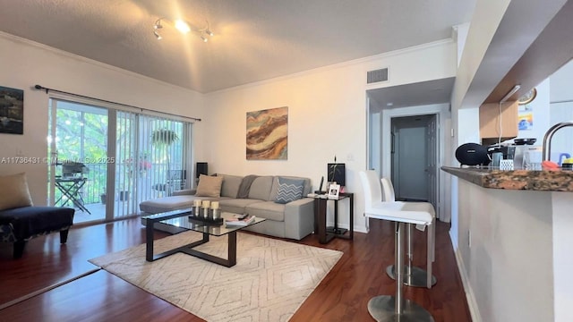 living room featuring crown molding, sink, and dark hardwood / wood-style flooring