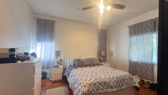 bedroom featuring ceiling fan, hardwood / wood-style floors, and multiple windows