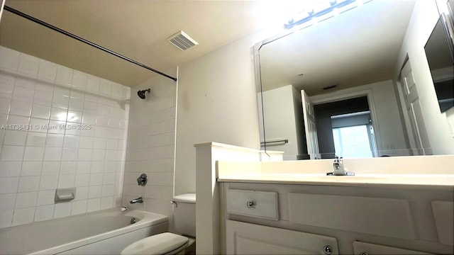 bathroom featuring shower / washtub combination, visible vents, toilet, and vanity