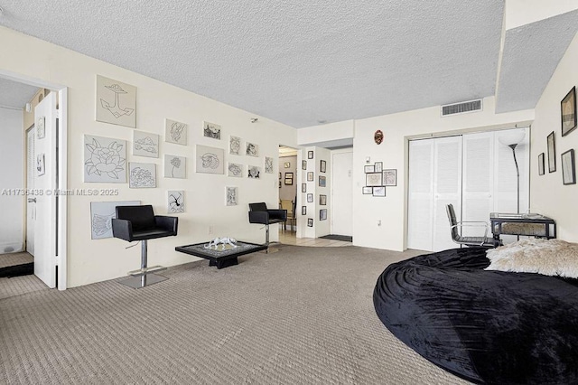 carpeted bedroom featuring a closet and a textured ceiling