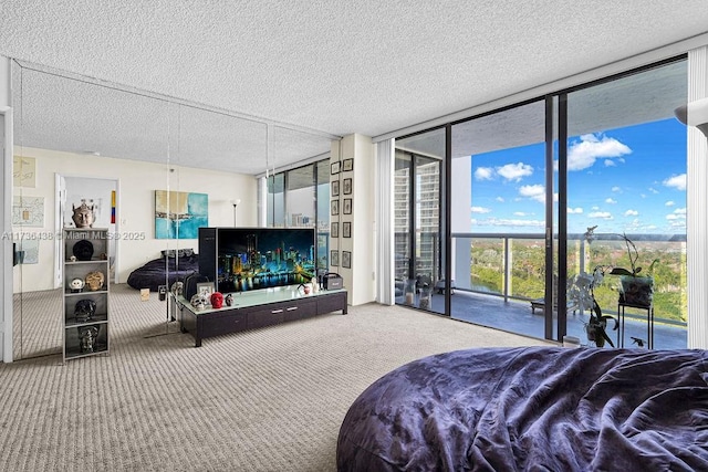 carpeted bedroom featuring access to outside, a textured ceiling, and a wall of windows