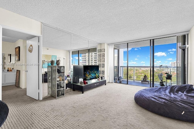 living room featuring expansive windows, carpet floors, and a textured ceiling