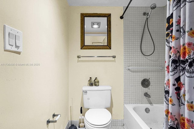 bathroom with tile patterned floors, shower / bath combination with curtain, and toilet