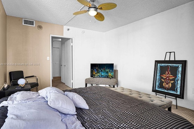 bedroom featuring a textured ceiling and ceiling fan