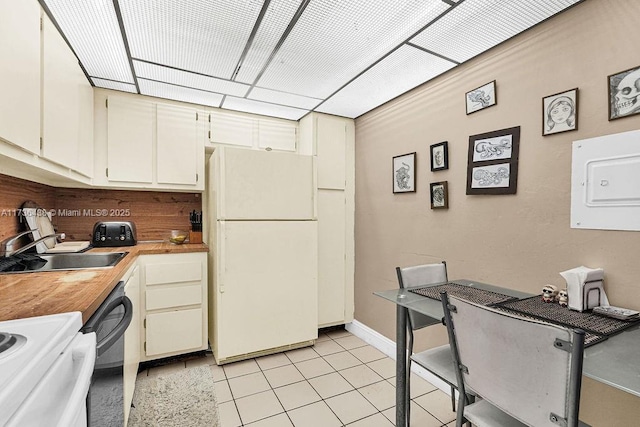 kitchen with dishwasher, white fridge, sink, and light tile patterned floors