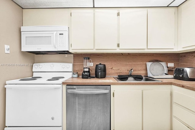 kitchen featuring white cabinetry, white appliances, and sink