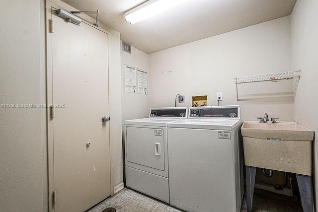 laundry room with sink and washer and dryer