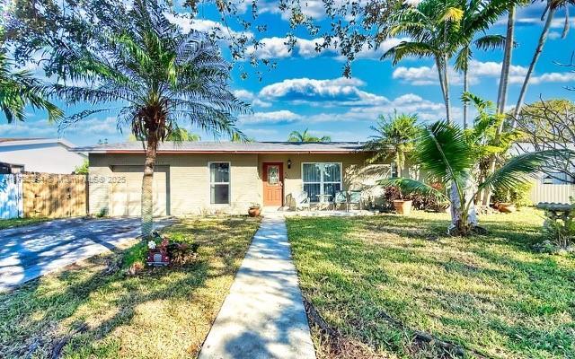 single story home with a garage and a front yard