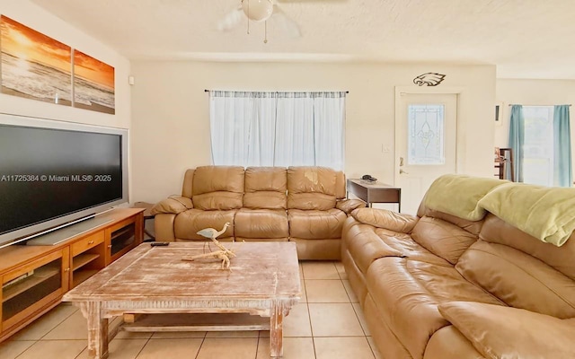 tiled living room featuring ceiling fan