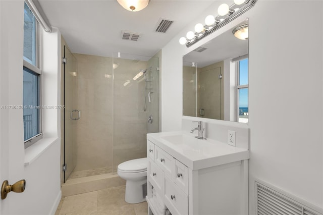 bathroom with vanity, tile patterned flooring, toilet, and walk in shower