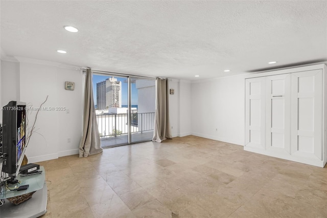 unfurnished living room featuring expansive windows, ornamental molding, and a textured ceiling