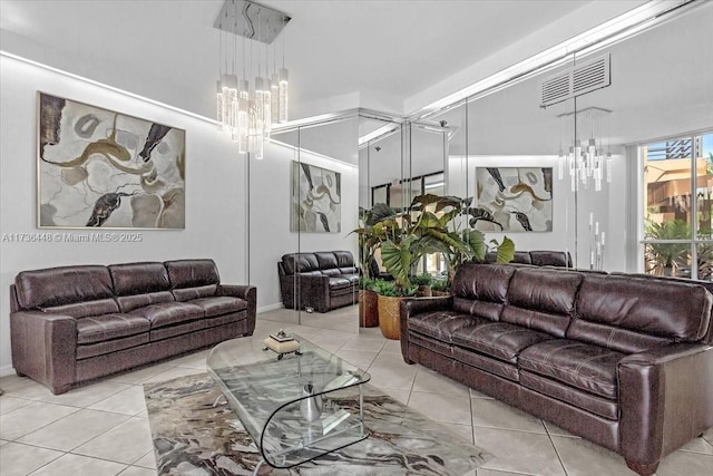 tiled living room featuring a notable chandelier